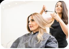 Image of a Woman receiving a haircut